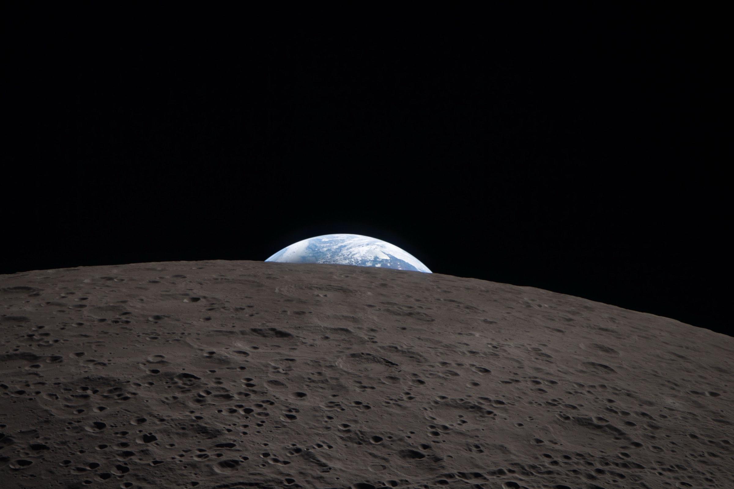 Earth setting behind the Moon, photographed from Orion